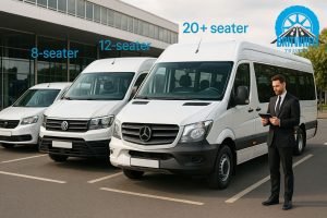 Row of 8-, 12- and 20+‑seater minibuses in UK setting with driver